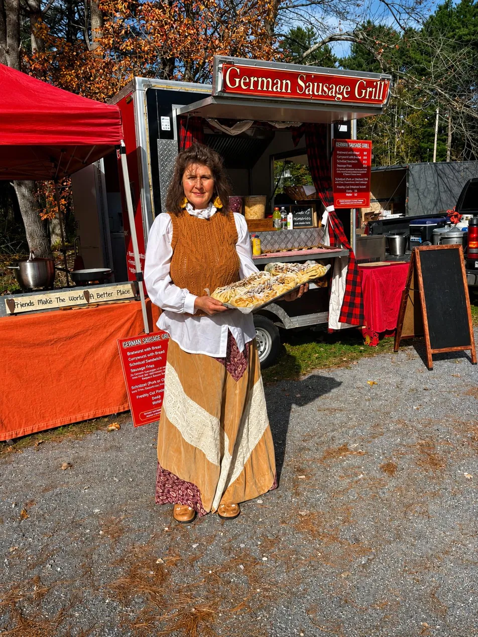 Petra, owner of Euro Bites, holding a tray of fresh pastries