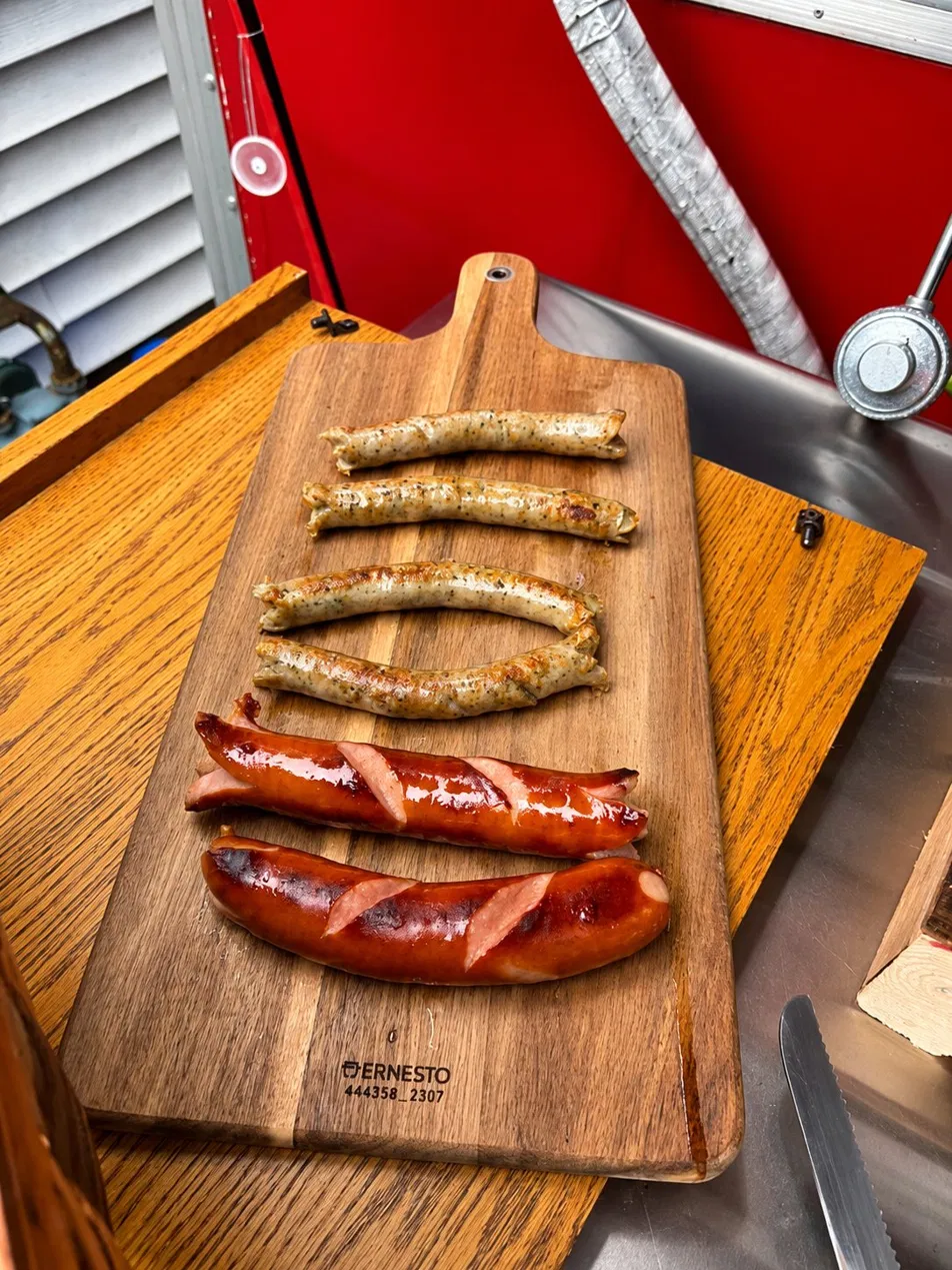Fresh sausages on a wooden board inside the Euro Bites truck